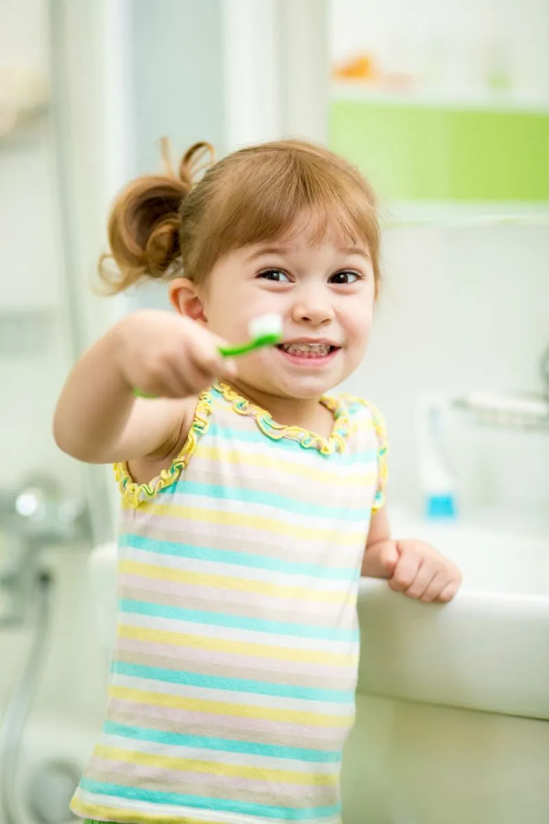 Little girl holding tooth brush